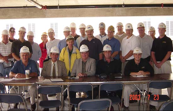 Representatives of AMEC, the construction trades, and OSHA at the Partnership's July 23, 2003 meeting. Front Row (left to right): Gary DiPaolo, Vice President Safety and Health, AMEC; Gary Anderson, Area Director OSHA Calumet City; Kathy O'Connell, Assistant Area Director, OSHA-Calumet City (standing); Rick Harbour, President, Compliance Safety Advocates; Andrew Schaeffer, Territory Safety Manager, AMEC-Central Region; Doug Anderson, Site Safety Manager, Compliance Safety Advocates. Back Row (left to right): Joe Knaff-OSHA, Craig Jorsch-Local 150, Scott Chinn-AFI, Michael Kennedy-AFI, Mona Block-Climatemp, Michael Clifford-Great Lakes Heating & Plumbing, Kevin Johnson-AMEC, Jim Lindquist-AFI, Steve Becker-Gibson Electric, Tom Barilich-AIG, Joe Charczencko-Zurich, Pete Portikis-MTH Industries, Tim Janis-Zurich, Tom Kavicky-UBC, Kenneth Borg-UBC, George Barton-CSA, and Kurt Krueger-CSA