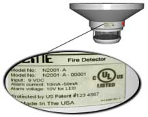 Smoke detector label enlarged in front of smoke detection device.
