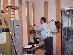 Figure 16. Restricted access or storage position may require reaching away from the body or above shoulder height to place a roll on the rack.