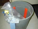 garbage can with orange strips on the inside.