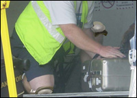 Figure 7. When pulling or pushing bags, use this kneeling position.