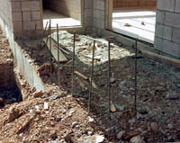 Construction site with unprocted steel rebar protruding from the ground