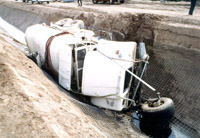 Large truck on its side in the trench