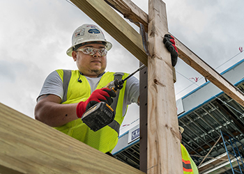 Construction worker in safety gear working on site